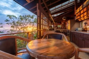 Indoor dining area with ocean view and sunset in Dominical, Costa Rica.