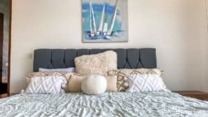 Modern bedroom with plush bedding and ocean-themed artwork in Dominical.