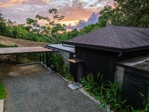 Contemporary house in Dominical with lush greenery and sunset sky.