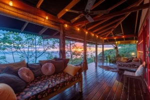 Relaxing ocean view deck with cozy seating and sunset scenery in Dominical.