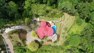 Aerial view of a Spanish-style home with pool and lush greenery in Dominical.