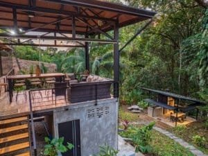 Outdoor living area with seating and lush tropical garden in Dominical.