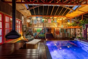 Stylish indoor pool with colorful decor and cozy seating in Costa Rica.