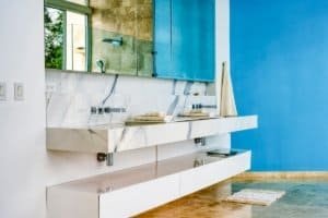 Contemporary bathroom with marble sink and blue wall in Costa Rica.