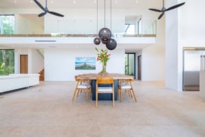 Spacious dining area with high ceilings, modern decor, and ocean view in Dominical.
