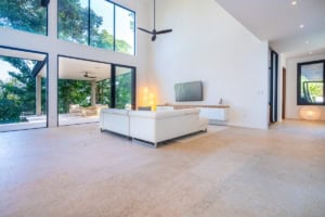 Spacious living room with large windows and ocean view in Costa Rica.