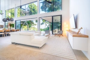 Bright living room with large windows and ocean view in Dominical, Costa Rica.