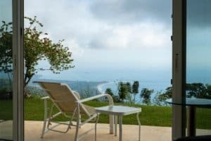 Relaxing ocean view from Costa Rica estate with chairs and lush greenery.