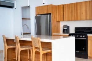 Contemporary kitchen with wooden cabinets, stainless steel appliances, and island.