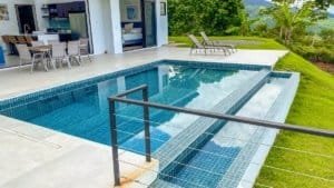 Modern pool area with mountain and ocean views in Dominical.