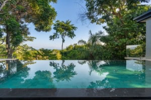 Scenic ocean view with lush tropical trees near Dominical, Costa Rica.