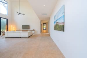 Bright living room with ocean view painting and large windows in Costa Rica.