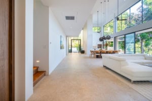 Spacious living room with large windows and tropical views in Dominical.