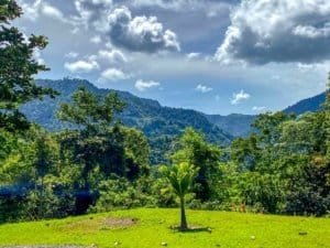 Lush green landscape with mountain and ocean views in Dominical, Costa Rica.