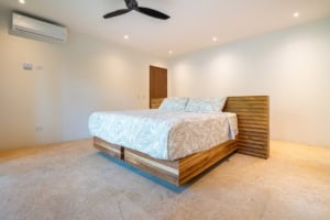 Spacious bedroom with wooden bed frame and modern decor in Costa Rica.