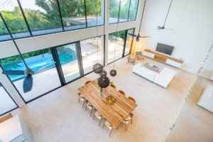 Spacious living and dining area with large windows and ocean view.