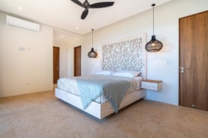 Modern bedroom with ocean view, stylish decor, and tropical ambiance.