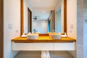 Modern bathroom with double vessel sinks and wooden countertop in Dominical.