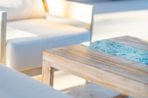 Outdoor seating with wooden table and white sofas in Costa Rica.