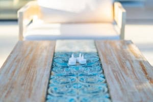 Outdoor wooden table with candles and ocean view in Dominical, Costa Rica.