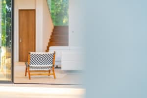 Contemporary living room with wooden stairs and stylish chair in Dominical.