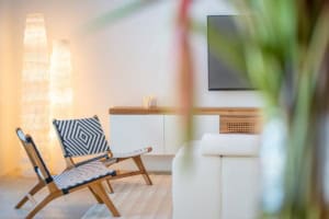 Bright and stylish living room with modern furniture and tropical accents.