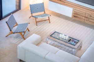 Contemporary living room with two patterned chairs and a white sofa.