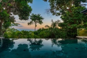 Infinity pool with tropical forest and ocean view in Dominical.