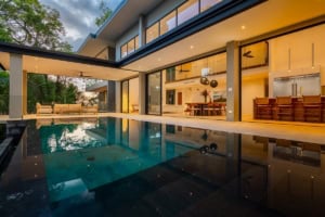 Modern tropical home with infinity pool, spacious outdoor living, and ocean views.