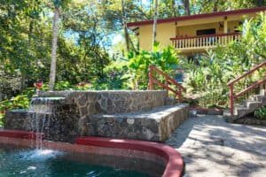 Gated condo with pool, jacuzzi, and lush tropical garden in Dominical.