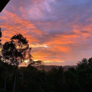 Beautiful sunset with colorful clouds over mountain landscape in Dominical.