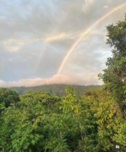 Double rainbow over lush green mountains in Dominical, Costa Rica.