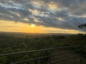Beautiful sunset over lush green landscape with cloudy sky in Dominical, Costa Rica.