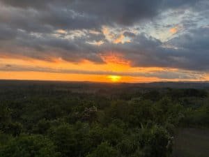 Beautiful sunset over lush green forest in Dominical, Costa Rica.