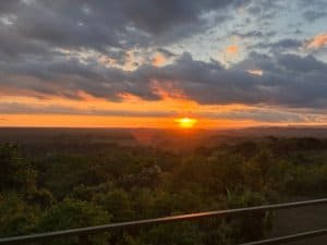 Beautiful sunset over lush green landscape with mountain and ocean view in Dominical.