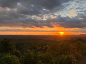 Beautiful sunset over lush rainforest with vibrant sky and clouds in Dominical, Costa Rica.
