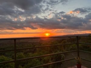 Stunning sunset view over mountains and ocean from a balcony in Dominical.