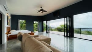 Spacious living room with ocean and waterfall views in Dominical, Costa Rica.