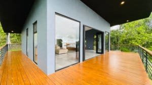 Spacious outdoor deck with glass doors and mountain views in Dominical.