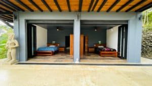 Two spacious bedroom suites with modern decor and open sliding doors.