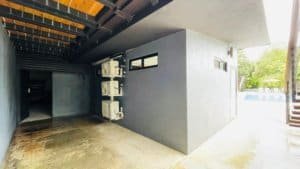 Contemporary building with gray walls and multiple air conditioning units in Dominical.