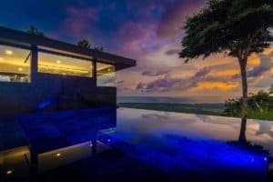 Modern Costa Rica home with infinity pool and panoramic ocean views at sunset.