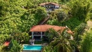 Beautiful ocean view home and boutique lodge in Dominical surrounded by lush greenery.