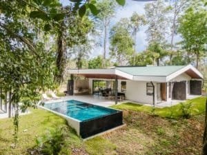 Modern private home with infinity pool in lush Costa Rica rainforest.