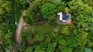 Aerial view of lush land with creek access near Dominical, Costa Rica.