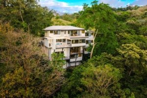 Modern multi-story house surrounded by lush green jungle in Costa Rica.