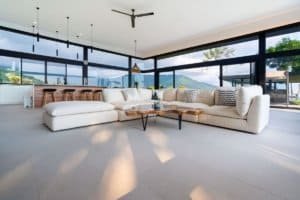 Spacious modern living room with large windows and mountain views.