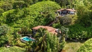 Beautiful Costa Rican property with ocean view, pool, and lush greenery.