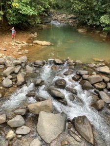 Scenic view of Nauyaca Waterfalls with rocks and lush greenery in Costa Rica.