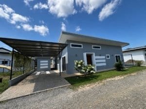Contemporary house in Dominical, Costa Rica with carport and garden.